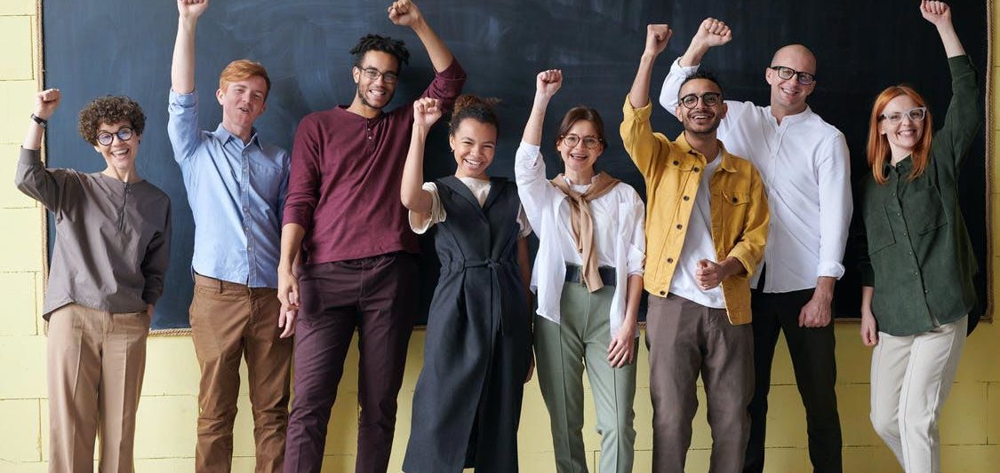 young group raising their hands